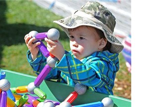 FILE - 2 year old Caleb Gee has fun at the Education Station at the International Children's Festival in St. Albert on Friday May 30, 2014.