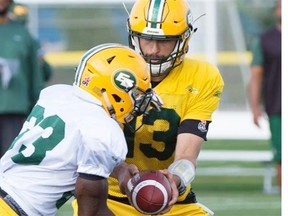 Eskimos quarterback Mike Reilly hands off to Shakir Bell at the Edmonton Eskimos training camp at Fuhr Sports Park in Spruce Grove on Wednesday.