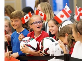 Fans wait for Canada’s national women’s soccer team to arrive at the Edmonton International Airport on June 2, 2015.