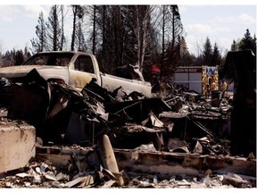 Firefighters work amongst the rubble on May 18, 2011 in Slave Lake after a fire destroyed entire neighbourhoods of the town.