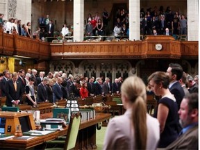 The House of Commons stands for a moment of silence on Parliament Hill on June 9, 2015 in Ottawa in honour of Edmonton police officer Constable Daniel Woodall, who was killed while on duty Monday.