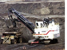 A hydraulic shovel loads a heavy hauler at an oilsands mine north of Fort McMurray in 2003.