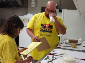 Ian Treuer, right, judges cheese at the inaugural Canadian Amateur Cheesemaking Awards in Picton, Ontario.