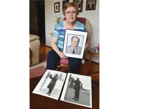 Janette Schwake with historic police photos taken by her husband Peter.