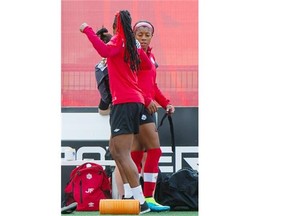 Kadeisha Buchanan, left, and Ashley Lawrence hang out together during Team Canada’s training session on Monday at Clareview Park.