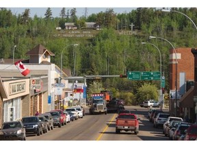 A large sign reminding citizens to help prevent forest fires looms over the town of Athabasca, on May 26, 2015.