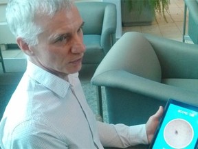 Liam Rourke shows an iPad with a training module he and his team created to help medical students learn how to better identify melanomas.