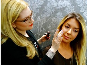 Makeup artist Kristi Dukovic gives fellow artist Francine Fotopoulos the no-makeup look.