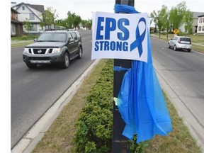 Many blue ribbons line the streets in Terwillegar to honour slain Constable Daniel Woodall in Edmonton on Thursday June 11, 2015.