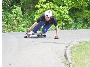 Matthew Van Buuren, 24, zips down Connors Hill while practising for the upcoming downhill skateboard racing season in Edmonton on June 8, 2015.