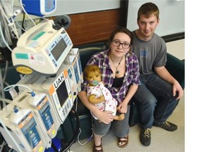 Meredith and Curtis Carlow with baby Naomi at the Stollery Children’s Hospital, where Naomi awaits a liver transplant