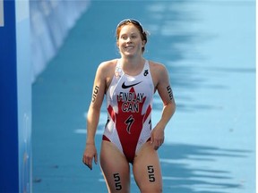 Edmonton's Paula Findlay crosses the finish line in the Elite Women's 2014 ITU World Triathlon Final in Edmonton on Saturday Aug. 30, 2014.