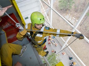 Patrick O'Callaghan prepares to rappel down from a tower to simulate rappelling from a helicopter into a forest during wildland firefighting training at the Hinton Training Centre run by Alberta Sustainable Resource Development in Hinton, Alta. on April 23, 2010.