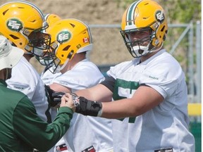 Offensive line coach Mike Scheper works with Rookie O linemen #57 David beard at the Eskimos training camp at Fuhr Sports Park in Spruce Grove. June 4, 2015.