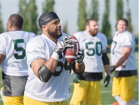 Offensive lineman Andrew Jones takes advantage of a rare chance to play with the football as the Edmonton Eskimos training camp gets underway on May 31, 2015, at Spruce Grove.