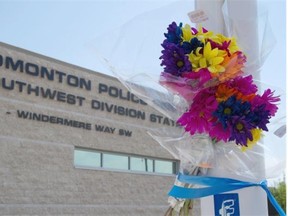 People have placed blue ribbons and flowers at Edmonton Police Service southwest division station to pay their respects to Const. Daniel Woodall in Edmonton.