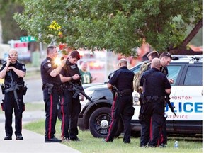 Police surround the scene where two officers were shot, one of them killed, in the west Edmonton neighbourhood of Callingwood on June 8, 2015.