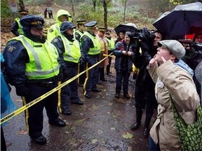 A protester, shouts at RCMP officers blocking the road on Burnaby Mountain where Kinder Morgan contractors are drilling a borehole in preparation for the Trans Mountain Pipeline expansion in Burnaby, B.C., in this Nov. 21, 2014 file photo.