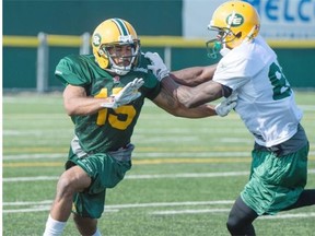 Rookie defensive back Deion Belue tries to fight off an attempted block by wide receiver Bryant Mitchell during an Edmonton Eskimos training camp practice at Fuhr Sports Park in Spruce Grove on Wednesday.