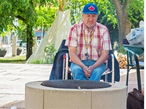 The sacred fire  in front of city hall to mark the closing of Canada's Truth and Reconciliation Commission is kept by Carl Rabbit of Maskwacis. The fire, a partnership of the City of Edmonton and the Confederacy of Treaty 6 First Nations, will be tended until Wednesday.