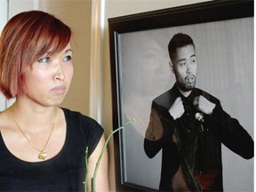 Sarena Armsworthy stands beside a photo of her brother Nara Pech, a 28-year-old Canadian university graduate who was found dead at the Wattay International Airport in Vientiane, Laos in January, 2015.