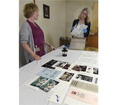 Jan Schimpf, right, and Christine Laverman pull items out of the time capsule from 1990 at the Misericordia Hospital on Monday, June 1, 2015.