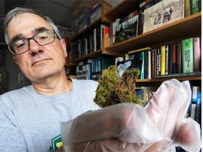 U of A scientist William Shotyk holds a moss sample in his office on the University of Alberta campus in Edmonton on Oct. 21, 2014. A controversial U of A study done by Shotyk that found no evidence of airborne pollution from oilsands operations is “misleading” and “fundamentally flawed,” say two scientists who study pollution.
