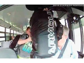 Screen capture from a video showing an incident on a school bus on May 25, 2015 where student hits the bus driver in the face with a bag