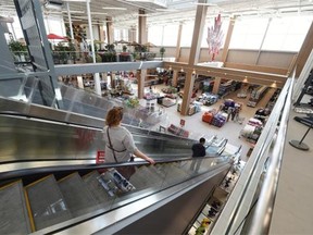 Shoppers ride the escalators in the giant new Canadian Tire store at South Edmonton Common in Edmonton on Monday, June 1, 2015.