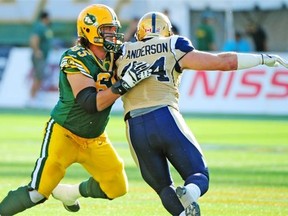 Simeon Rottier protects the quarterback as the Edmonton Eskimos battle the Winnipeg Blue Bombers at Commonwealth Stadium in Edmonton in September 2013.