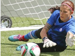 Team Canada goalkeeper Stephanie Labbe dives to block a shot during Friday’s practice at Commonwealth Stadium.