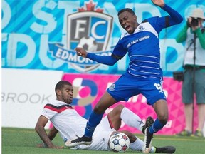 Tomi Ameobi of FC Edmonton is taken down by Rauwshan McKenzie of the Atlanta Silverbacks during Sunday’s North American Soccer League game at Clarke Field.