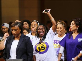 Union workers cheer as Los Angeles city council gave initial approval May 19, 2015 to raising minimum pay in the nation’s second-largest city to $15 an hour by 2020.