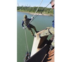 Warrant Officer Dany Heppell starts Cpl. Alexander Senechal off on his rappel down the Ainsworth Dyer Bridge, as about 120 soldiers from 1 Service Battalion took part in training at Rundle Park as part of the Command Officerís physical training event  on Friday May 29, 2015.