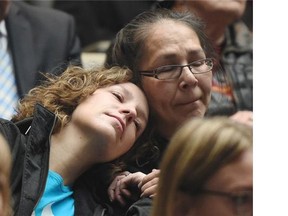 Co-workers from the Boyle Street Centre Brandy Basisty, left, and Noreen Quinney watch the Truth and Reconciliation Commission’s release of its final report on residential schools, livestreamed from Ottawa, in Edmonton city council chambers on Tuesday, June 2, 2015.