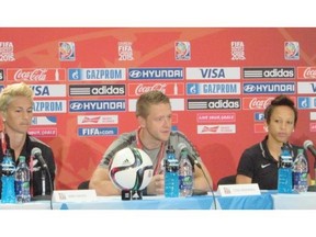 New Zealand coach Tony Readings, centre, speaks at a Women’s World Cup news conference with players Abby Erceg, left, and Sarah Gregorius at Commonwealth Stadium on Friday, June 5, 2015.