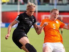 New Zealand forward Hannah Wilkinson, left, pulls the ball away from Petra Hogewoning of the Netherlands during a Women’s World Cup soccer game at Commonwealth Stadium on June 6, 2015.