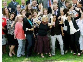 Alberta Premier Rachel Notley and Alberta NDP MLAs break out in dance after getting a group photo taken outside the Alberta Legislature in Edmonton on June 25, 2015.