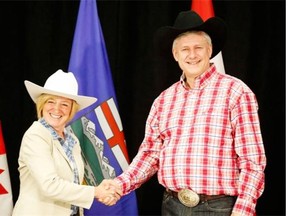 Alberta Premier Rachel Notley greets Prime Minister Stephen Harper with a handshake on Monday, July 6, 2015 during the Calgary Stampede.