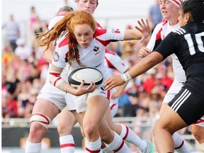 Andrea Burk of Canada heads for the goal line during a Women’s Rugby Super Series game against the New Zealand Black Ferns at Calgary Rugby Park on June 27, 2015.