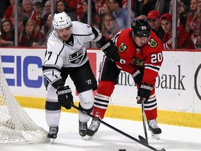 Andrej Sekera, then of Los Angeles Kings, checks Brandon Saad, then of Chicago Black Hawks, in a late-season game between Western Conference powers.