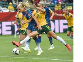 Australia’s Alanna Kennedy (14) tries to stop Sweden’s Sofia Jakobsson (10) as she got a shot off during the FIFA Women’s World Cup Group D match at Commonwealth Stadium on Tuesday.
