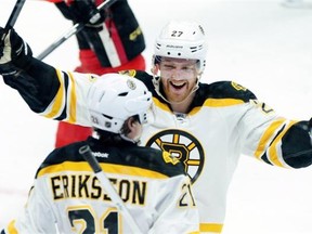 Boston Bruins defenceman Dougie Hamilton congratulates teammate Loui Eriksson on his goal during an NHL game against the Ottawa Senators on March 10, 2015.