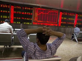 Chinese investors monitor stock prices at a brokerage house in Beijing, China, Thursday, July 9, 2015.
