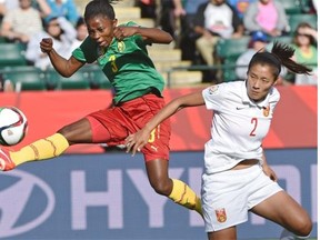Cameroon’s Ajara Nchout takes a shot on goal next to China’s Liu Shanshan (2) during round of 16 play at the FIFA Women’s World Cup at Commonwealth Stadium on Saturday, June 20, 2015.