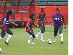 Cameroon’s Gabrielle Onguene (7, middle) works with teammates during in a training session in Edmonton Friday in preparation for their match against China at Commonwealth Stadium on Saturday.