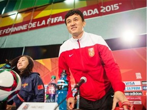 China’s head coach Hao Wei arrives for his team’s press conference at the FIFA Women’s World Cup in Edmonton, Canada, on June 19, 2015. China is set to meet Cameroon in their Group of 16 football match on June 20.