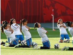 Colombia’s players stretch during Sunday’s training session in preparation for Monday’s Women’s World cup soccer match against the United States at Commonwealth Stadium.