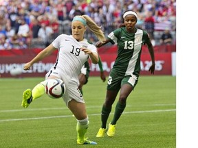 USA defender Julie Johnston (L) and Nigeria forward Ngozi Okobi fight for the ball during a Group C football match between Nigeria and USA at BC Place Stadium in Vancouver during the FIFA Women’s World Cup Canada 2015 on June 16, 2015. The USA won 1-0.
