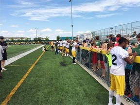 Edmonton Eskimos rookie Etauj Allen signs autographs for fans at Spruce Grove’s Fuhr Sports Park during training camp in June 2015.